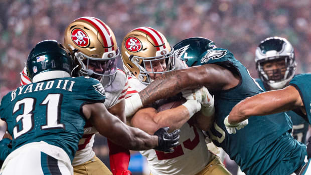 Philadelphia Eagles defensive tackle Jalen Carter (98) tackles San Francisco 49ers running back Christian McCaffrey (23) during the second quarter at Lincoln Financial Field.